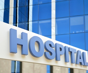 Hospital building sign closeup, with sky reflecting in the glass. 3d rendering